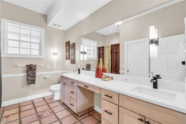 685 11th St NW, Naples, FL 34120 - full bath featuring toilet, double vanity, and baseboards