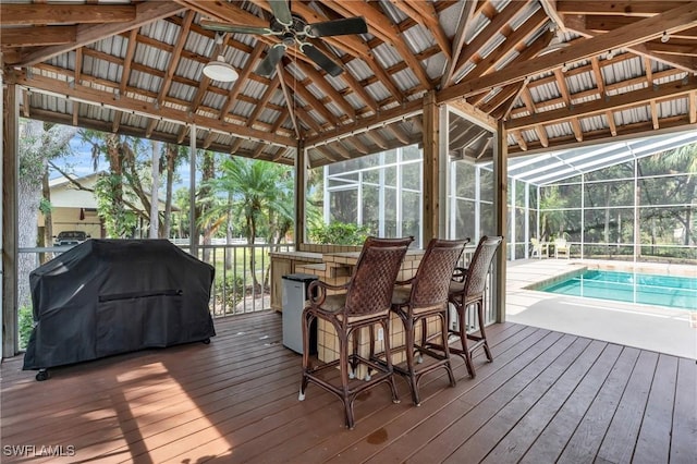 685 11th St NW, Naples, FL 34120 - wooden terrace featuring grilling area, a ceiling fan, an outdoor pool, and glass enclosure