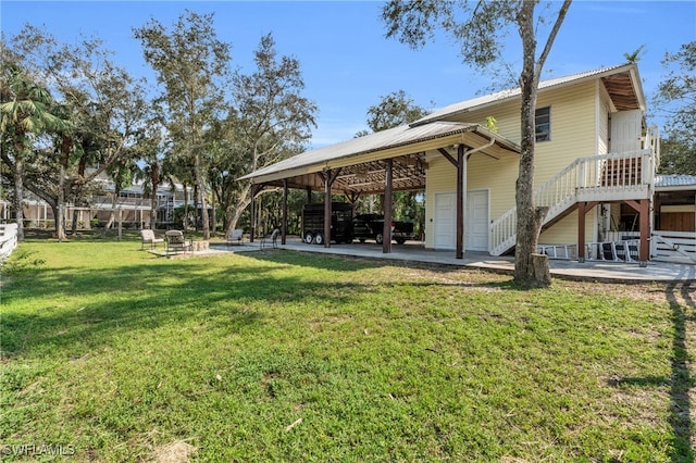 rear view of property with a wooden deck, a yard, and a patio area