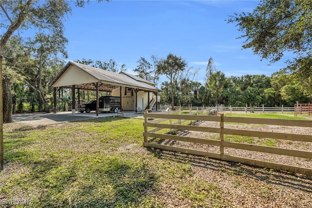 view of yard featuring a carport and a rural view