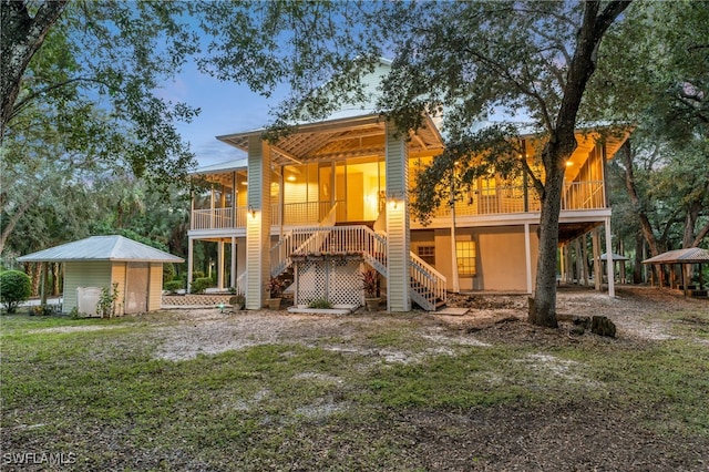 back house at dusk featuring a yard