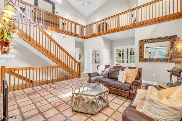 living room featuring ceiling fan and a high ceiling