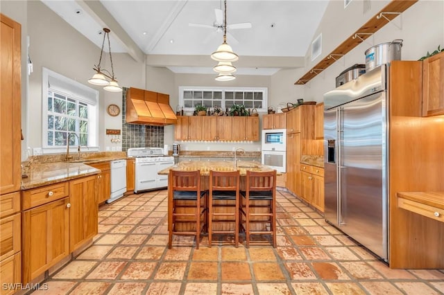 685 11th St NW, Naples, FL 34120 - kitchen featuring built in appliances, a sink, custom exhaust hood, beam ceiling, and light stone countertops