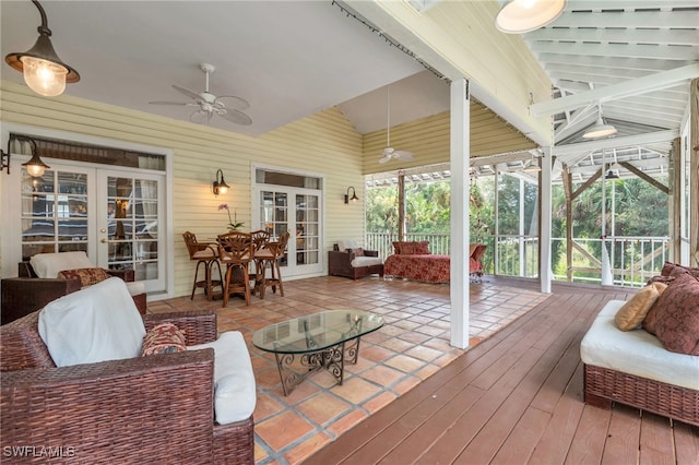 sunroom with french doors, ceiling fan, and vaulted ceiling