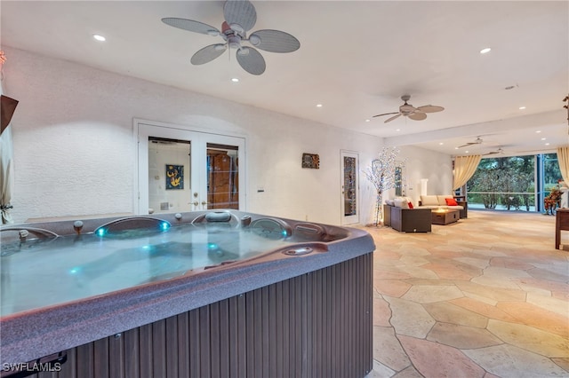 view of patio featuring a hot tub and ceiling fan