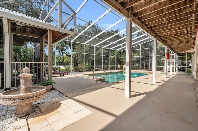 view of swimming pool with a patio and glass enclosure