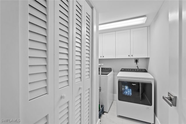 laundry area with cabinets and washing machine and clothes dryer