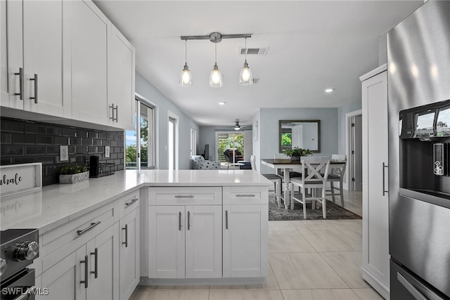 kitchen with stainless steel fridge with ice dispenser, kitchen peninsula, white cabinetry, and light tile patterned floors