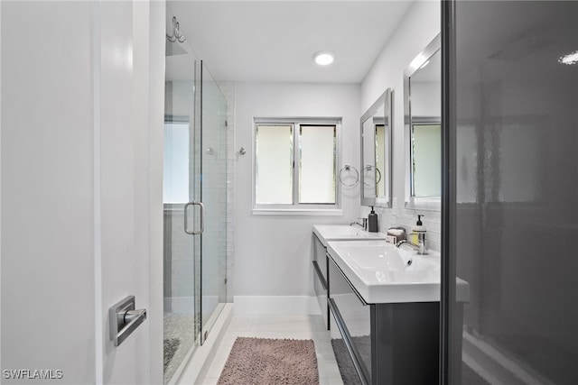 bathroom with vanity, tile patterned flooring, backsplash, and walk in shower