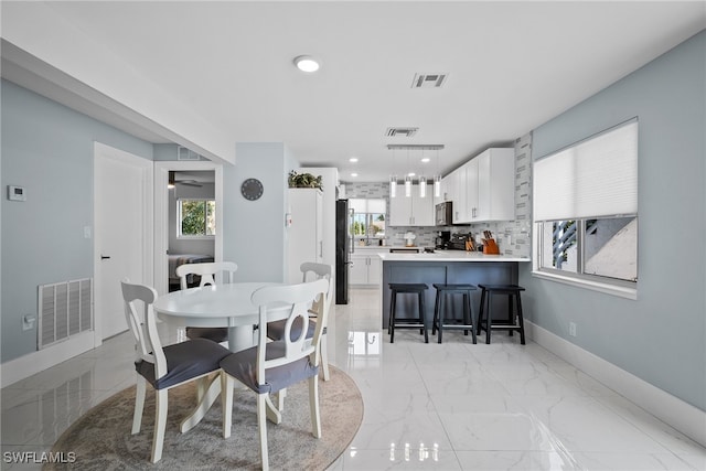 dining room featuring ceiling fan