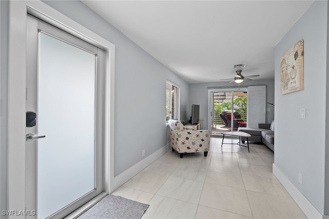 living room featuring light tile patterned flooring and ceiling fan