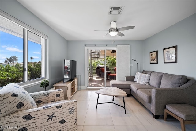 living room featuring light tile patterned flooring and ceiling fan