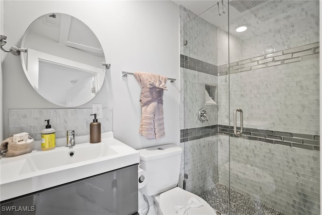 bathroom with toilet, an enclosed shower, decorative backsplash, and vanity