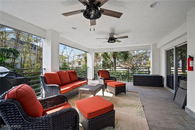 sunroom featuring ceiling fan