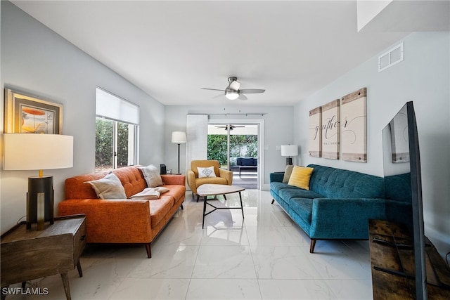 living room featuring a wealth of natural light and ceiling fan