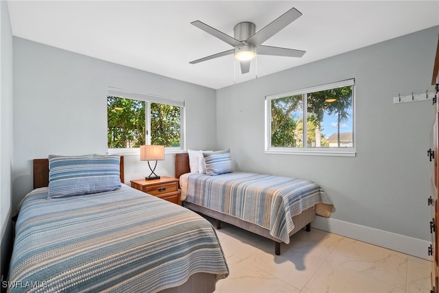 bedroom featuring ceiling fan and multiple windows