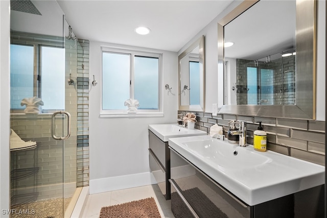 bathroom featuring vanity, tasteful backsplash, a shower with shower door, and tile patterned floors