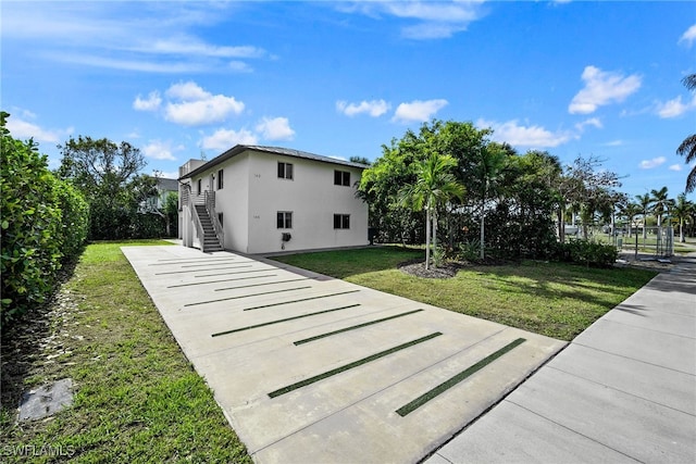 view of side of property with a lawn