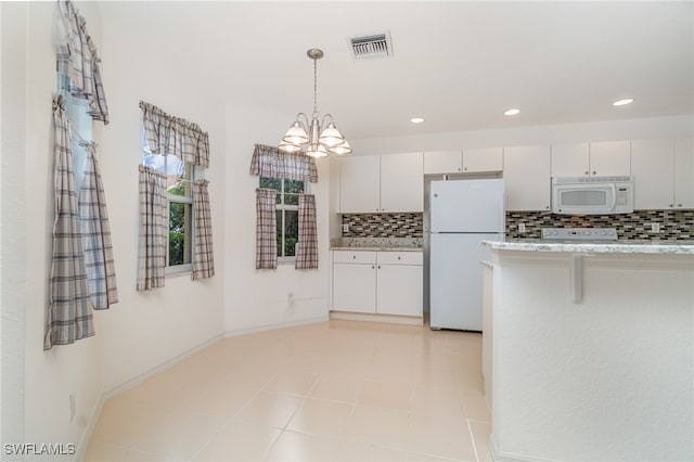 kitchen featuring a breakfast bar area, pendant lighting, white cabinetry, white appliances, and tasteful backsplash