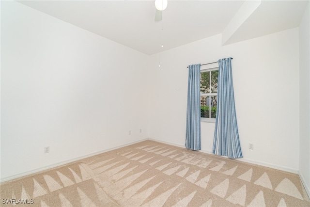 carpeted empty room featuring ceiling fan