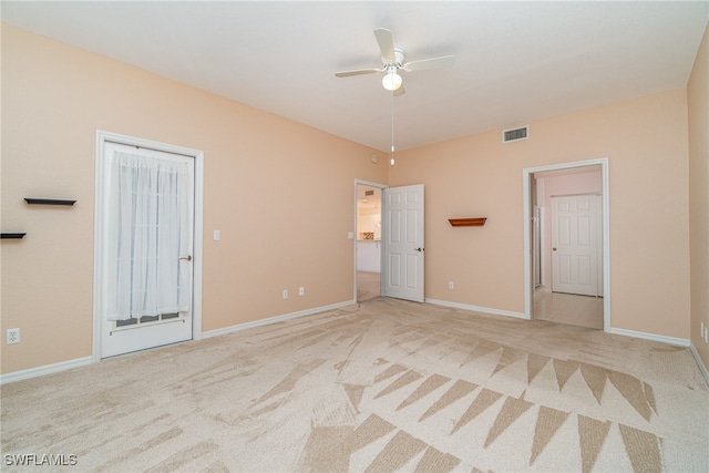 carpeted spare room featuring ceiling fan