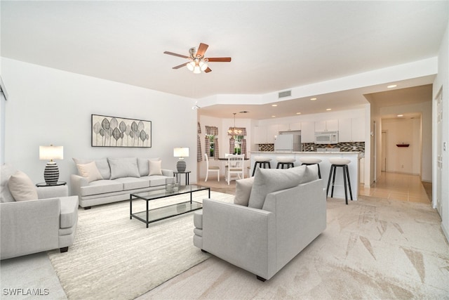 living room featuring light colored carpet and ceiling fan