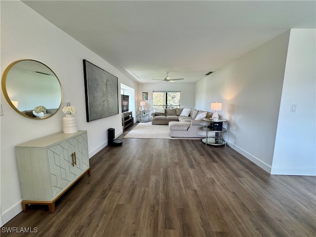 living room with ceiling fan and dark wood-type flooring