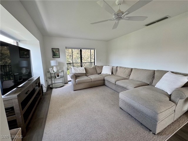 living room with ceiling fan and hardwood / wood-style flooring