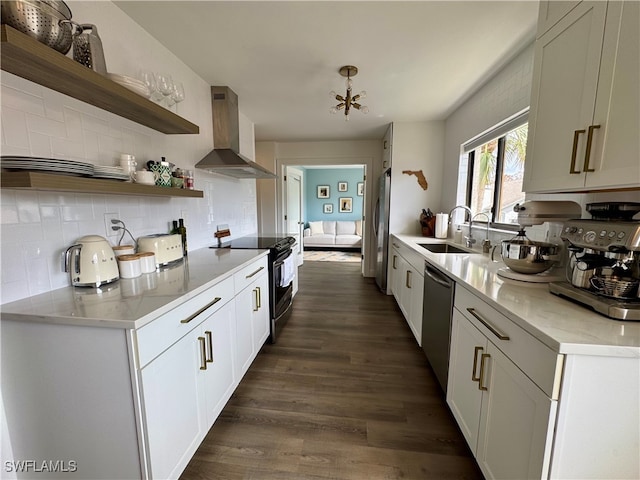 kitchen featuring stainless steel appliances, sink, wall chimney range hood, white cabinets, and dark hardwood / wood-style floors