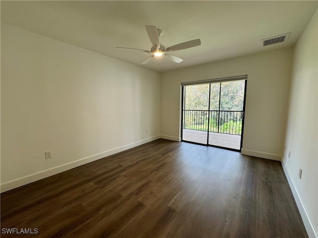 unfurnished room featuring ceiling fan and dark wood-type flooring