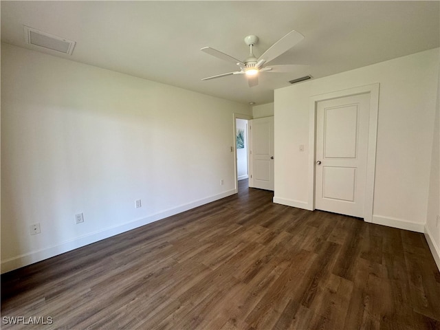 spare room featuring ceiling fan and dark hardwood / wood-style floors