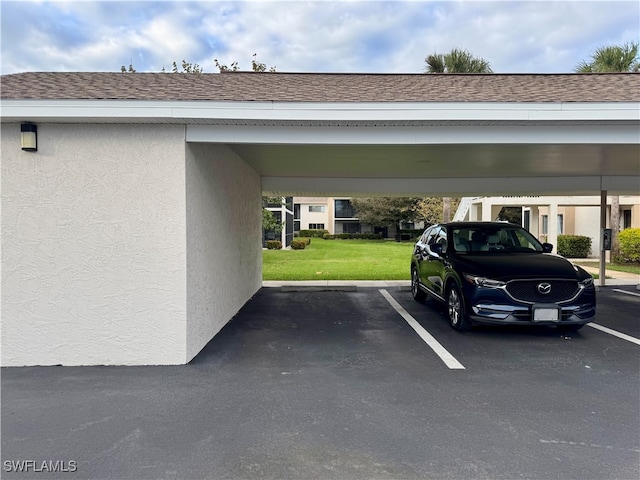 view of parking / parking lot featuring a lawn