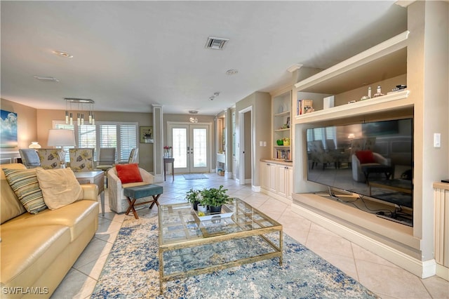 living room featuring built in shelves, french doors, and light tile patterned flooring