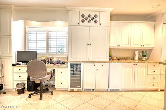 office featuring light tile patterned flooring, ornamental molding, and beverage cooler