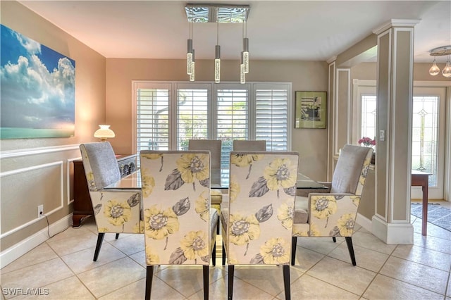 tiled dining space featuring ornate columns