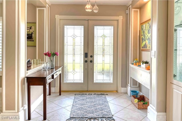 entryway featuring french doors, light tile patterned floors, and a wealth of natural light