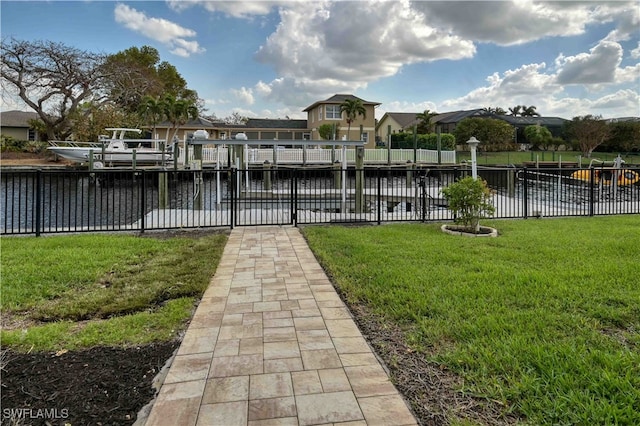 dock area featuring a yard and a water view