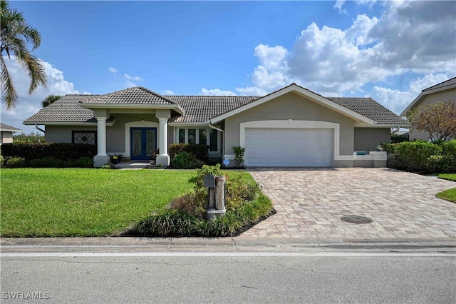 view of front of house featuring a front yard and a garage