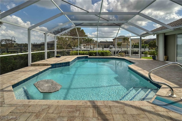 view of swimming pool featuring a lanai and a patio