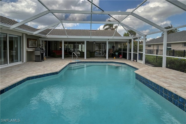 view of swimming pool with a lanai, a patio area, and grilling area