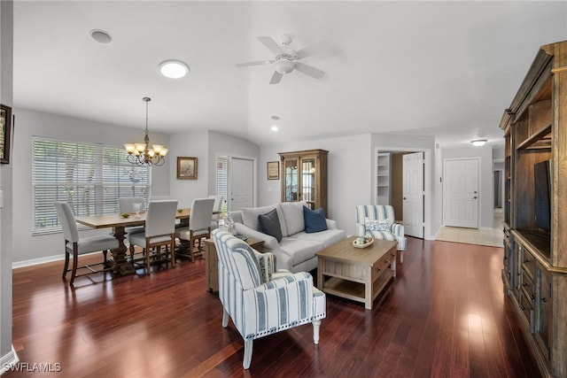 living room with vaulted ceiling, dark hardwood / wood-style floors, and ceiling fan with notable chandelier