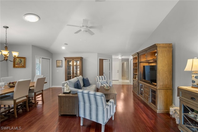 living room featuring lofted ceiling, dark hardwood / wood-style floors, and ceiling fan with notable chandelier