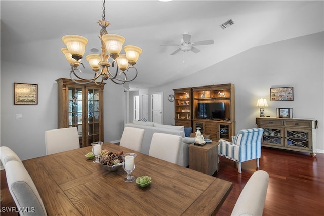 dining area with ceiling fan with notable chandelier, vaulted ceiling, and dark hardwood / wood-style floors