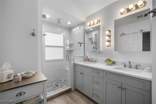 bathroom featuring vanity, hardwood / wood-style flooring, lofted ceiling, and an enclosed shower