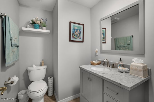 bathroom featuring toilet, hardwood / wood-style floors, and vanity