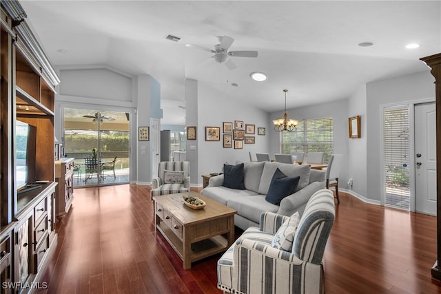 living room with vaulted ceiling, plenty of natural light, ceiling fan with notable chandelier, and dark hardwood / wood-style flooring