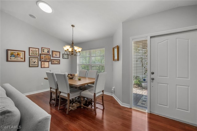 dining area featuring lofted ceiling, a chandelier, and dark hardwood / wood-style flooring