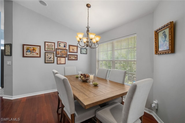 dining space featuring lofted ceiling, a chandelier, and dark hardwood / wood-style floors