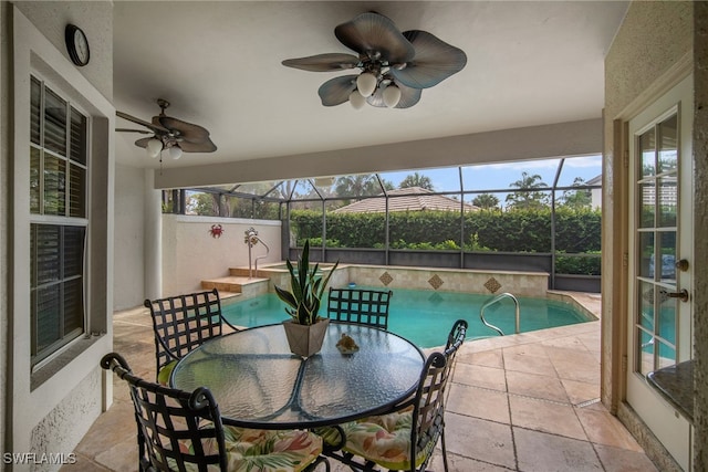 view of pool featuring a patio, ceiling fan, and a lanai