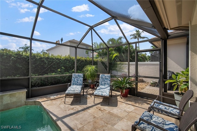 view of patio featuring glass enclosure